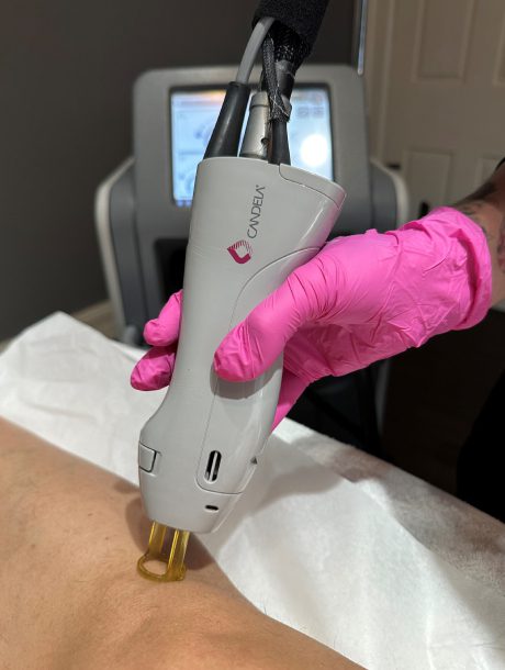 A person holding an electric device in their hand.