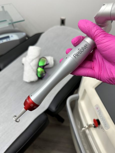 A person holding a dental instrument in their hand.