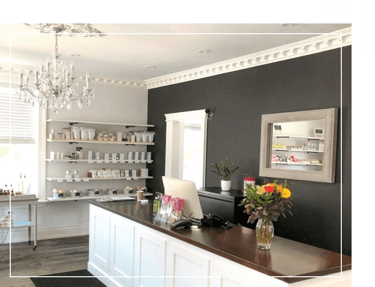A room with a counter and shelves of cups