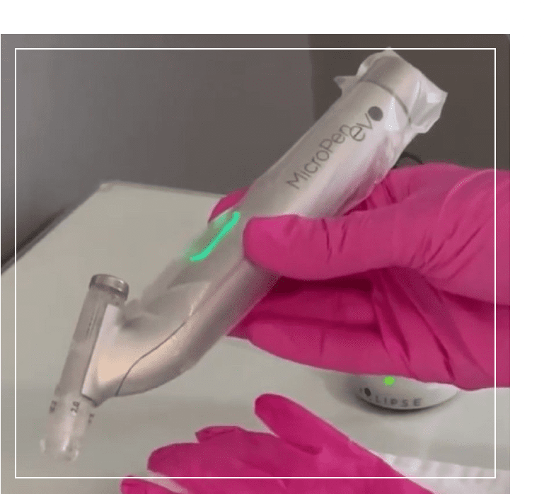 A person wearing pink gloves holding a razor.